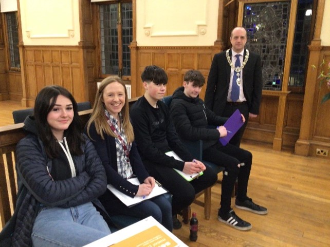 Image shows the Young people, youth worker and Councillor at the council meeting.