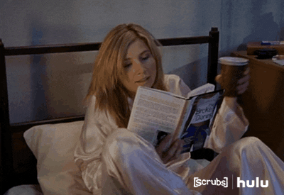 Elliot from Scrubs getting comfy in bed with a book