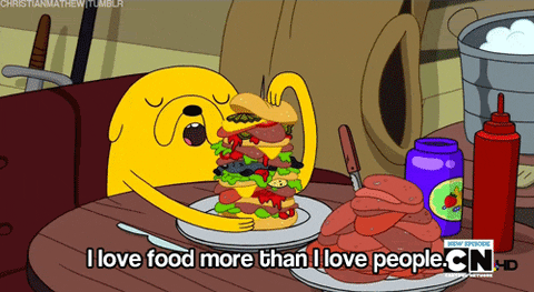 Jake from Adventure Time with a plate of food saying "I love food more than I love people"