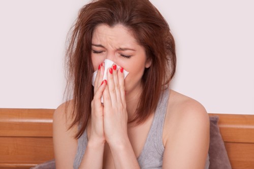 A picture of a woman blowing her nose