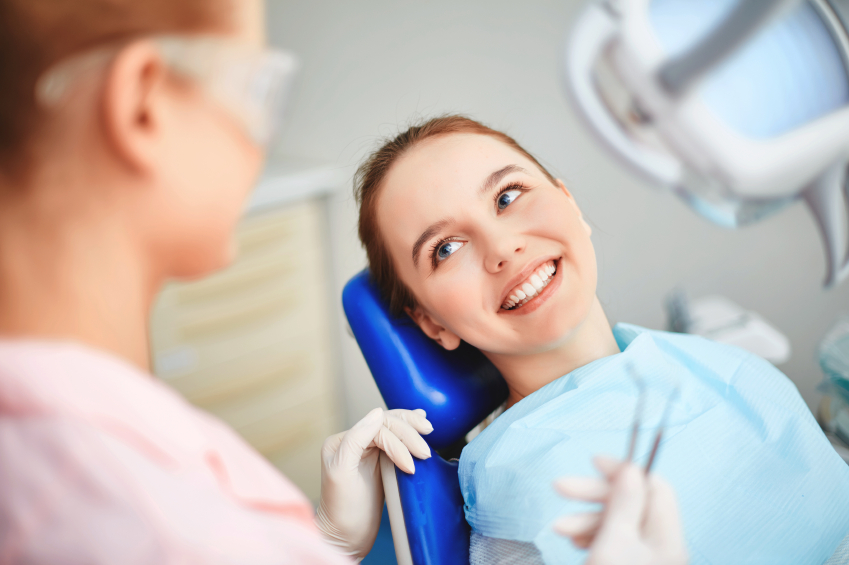 A picture of a woman sitting in a dentists  chair
