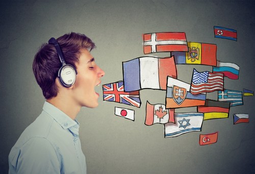 Boy with mouth open and different countries' flags coming out