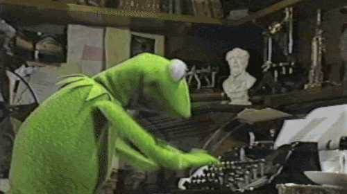 Kermit the frog typing rapidly on a typewriter